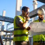 Architect and engineer construction workers working at outdoors construction site